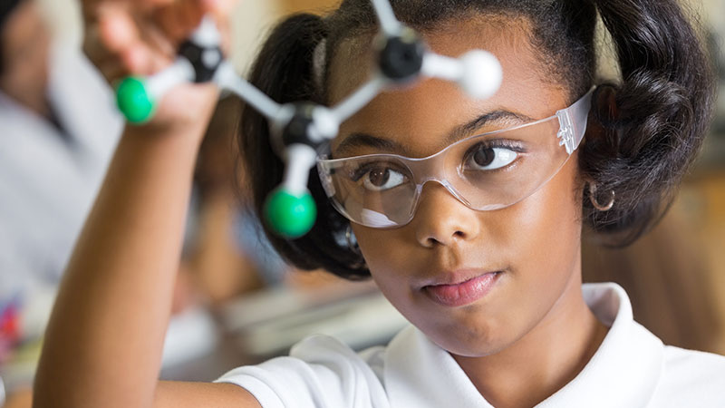 A middle school student in science lab.