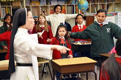 Children sing at Saint Rita Catholic School